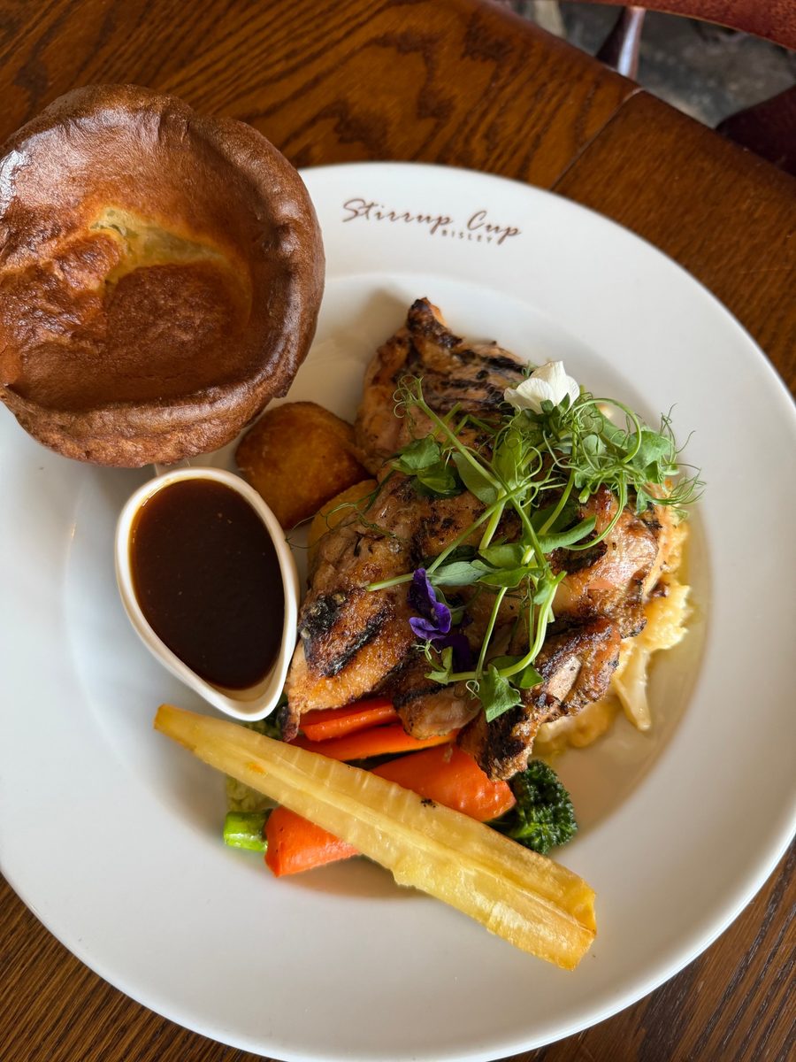 Sunday roast chicken with Yorkshire pudding, roast potatoes, seasonal vegetables and gravy at The Stirrup Cup in Bisley, Gloucestershire.